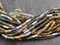 9x4mm Aged Matte Wampum Mural Picasso Bugle Bead Mix (21" Strand)